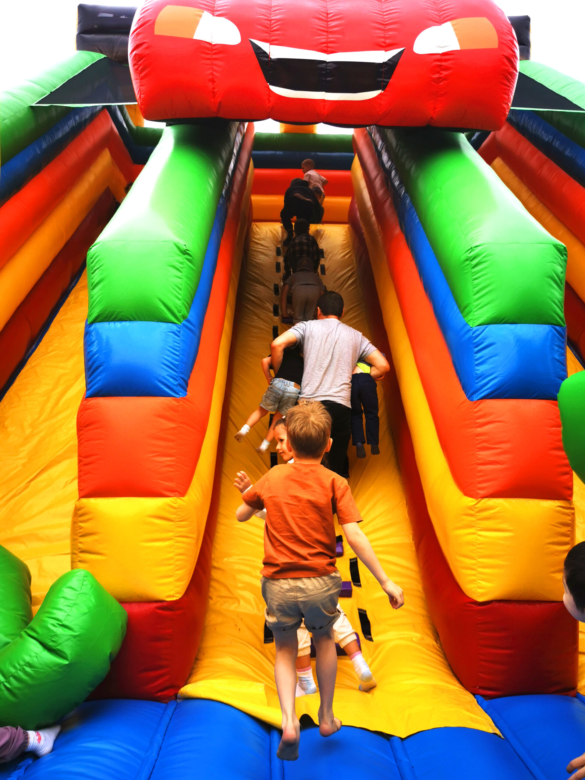 backyard celebrations shows family going up bounce house
